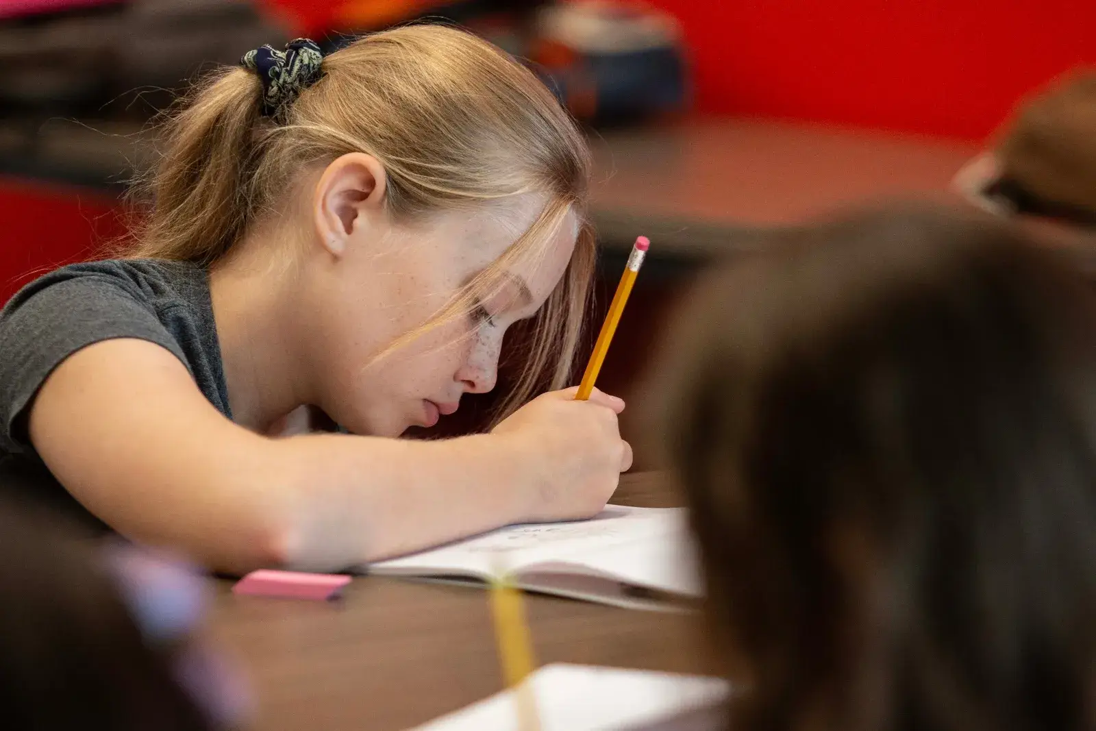 Close-up of a girl drawing at a table